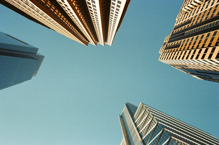 Skyscrapers seen from below against a blue sky