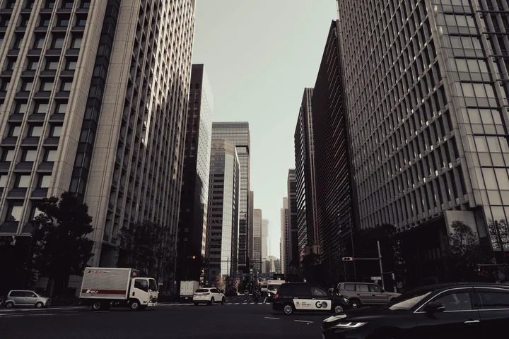 A city street between tall office buildings